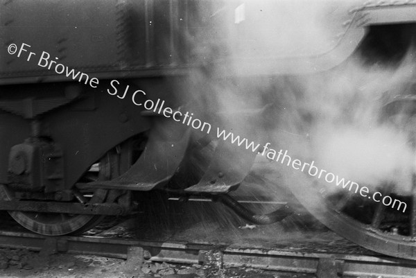 TRAINS CLOSE UP OF LOCO WHEEL WITH STEAM